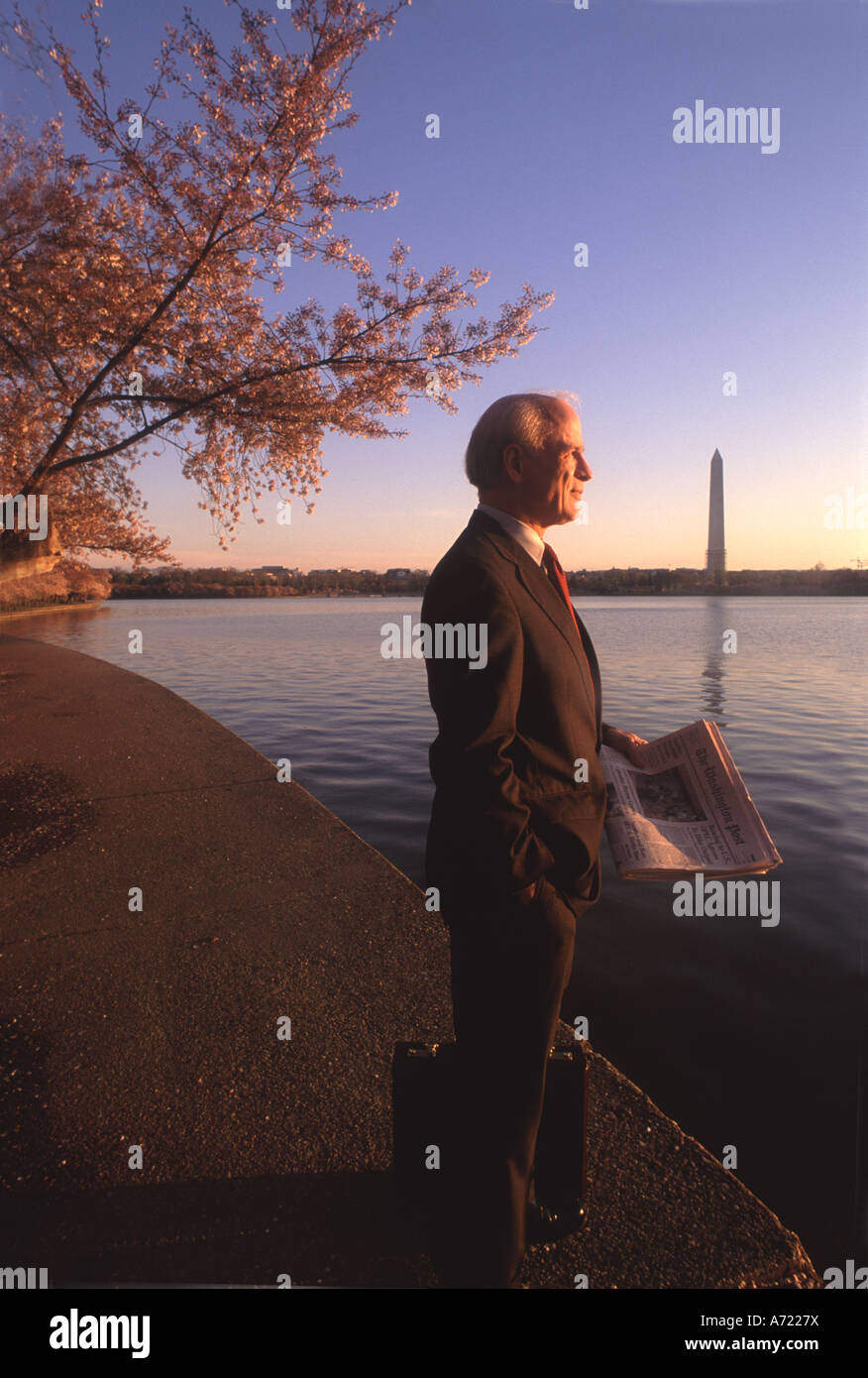 A lawyer stands by the Potomac with the Jefferson Memorial behind him Stock Photo