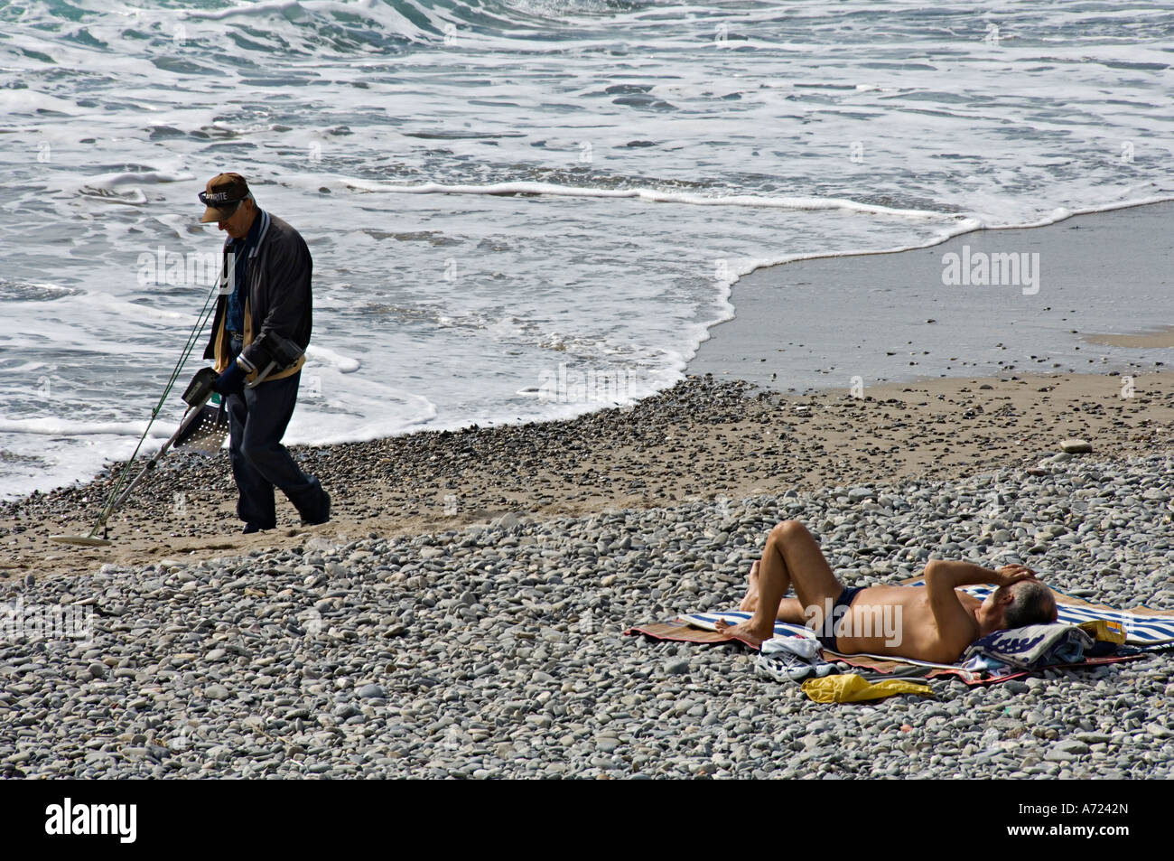 Beach metal detecting Promenade des Anglais, Nice Cote d'Azur France French Riviera Stock