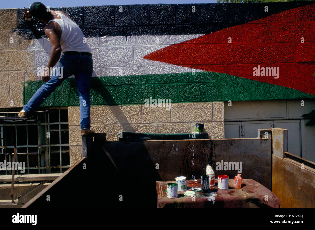 Jericho, Sept 13th 1993; A painter paints a Palestinian flag on the wall of the town's petrol station. Stock Photo