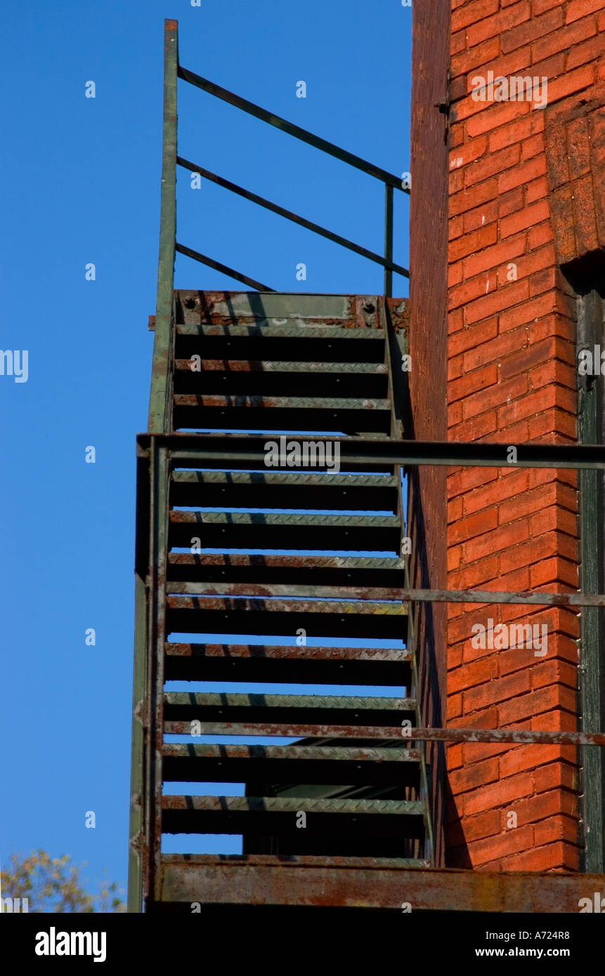 Fire escape ladder on side of brick building Stock Photo - Alamy
