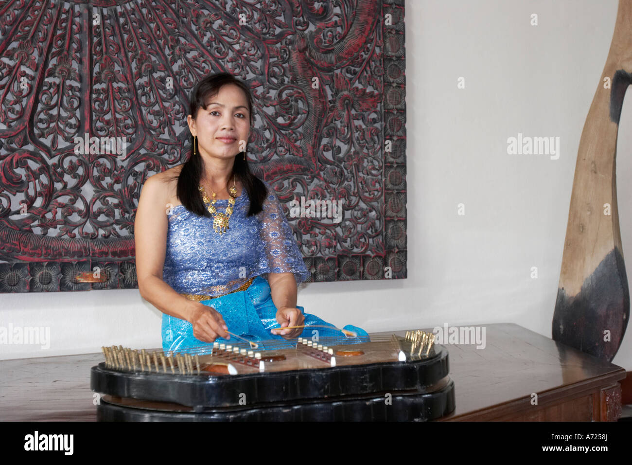 Woman playing khim, traditional Thai musical instrument. Phuket