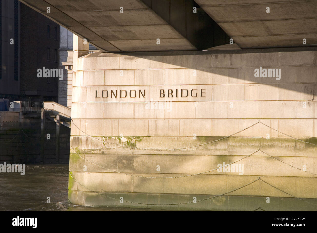 Beneath London Bridge taken from the River Thames in sun sunshine London England GB Great Britain UK United Kingdom British Stock Photo
