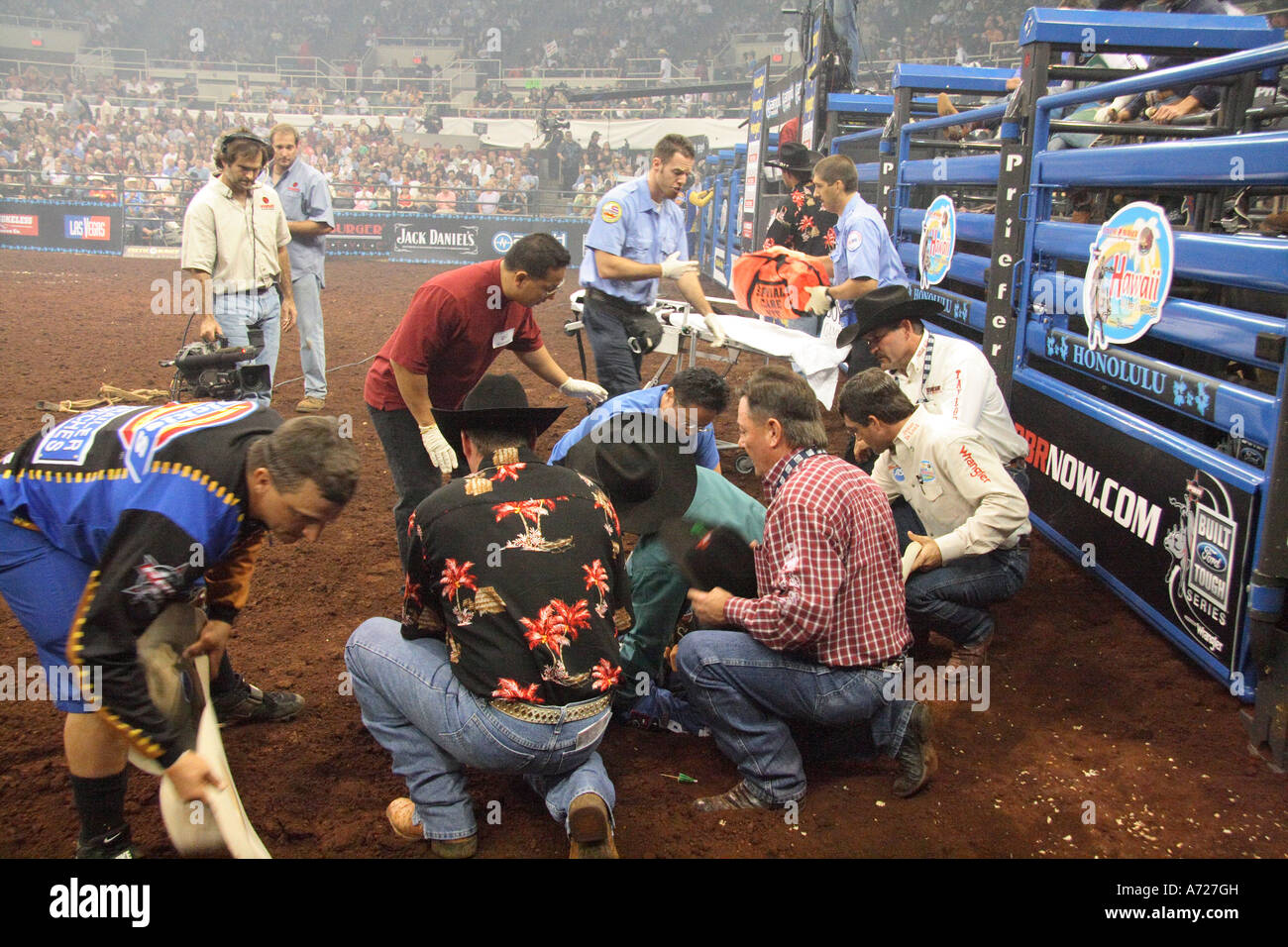 People attending to Chris Shivers after a bull stepped on his leg, badly fracturing it. Stock Photo