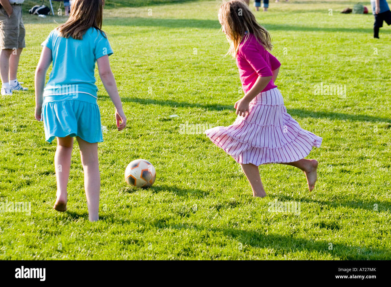 Girls age 11 playing soccer barefooted in skirts. Carondelet Field Expo School St Paul Minnesota USA Stock Photo