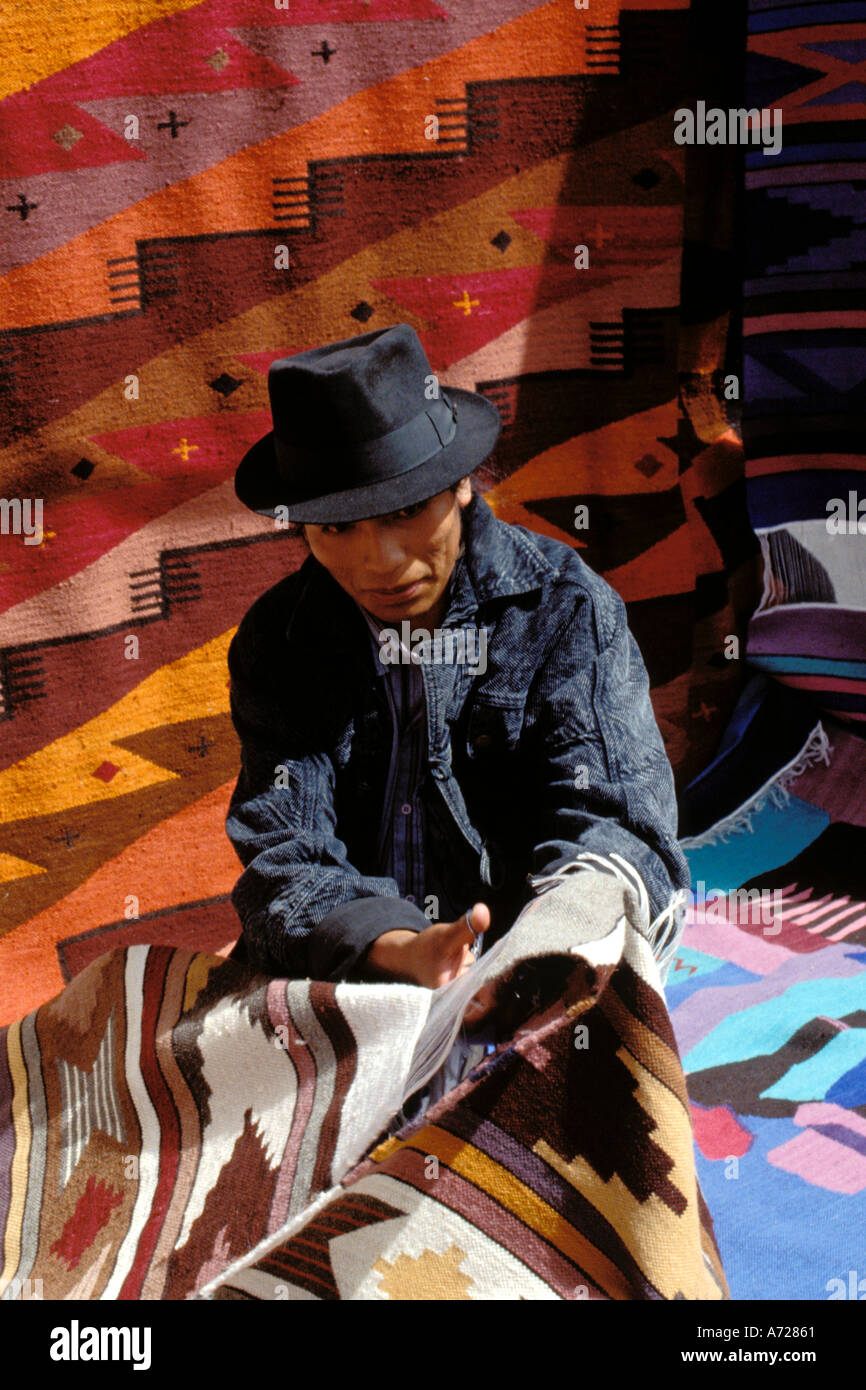 Ecuador, Otavalo, Weaver selling his rugs in the market Stock Photo - Alamy