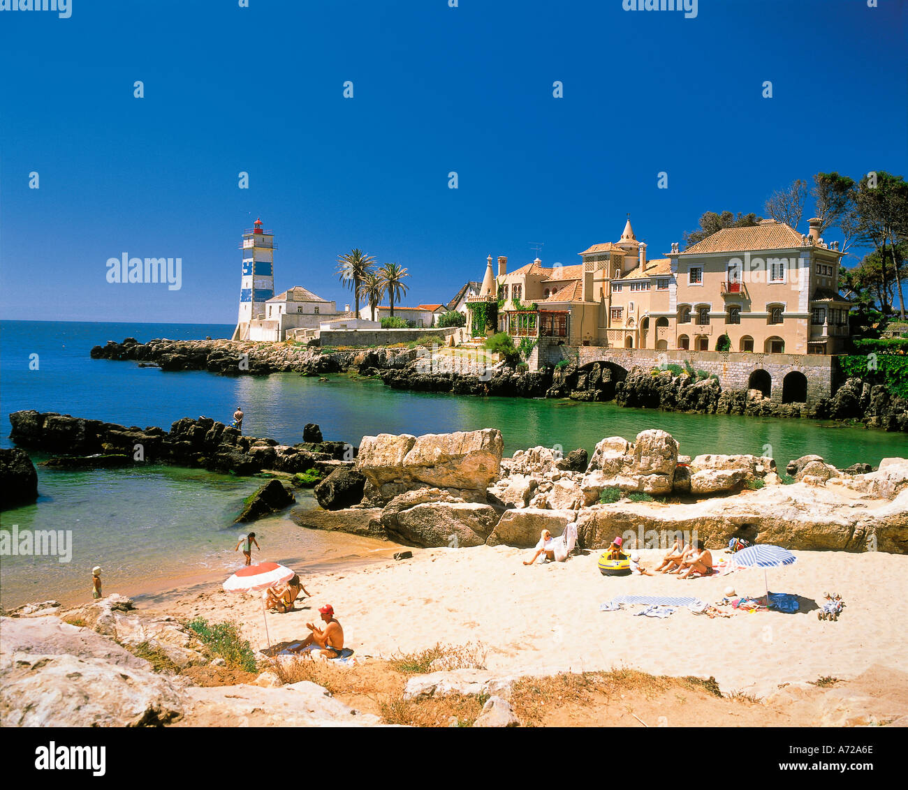 Tourists on the beach and Lighthouse at Cascais on the Lisbon coast Portugal Stock Photo