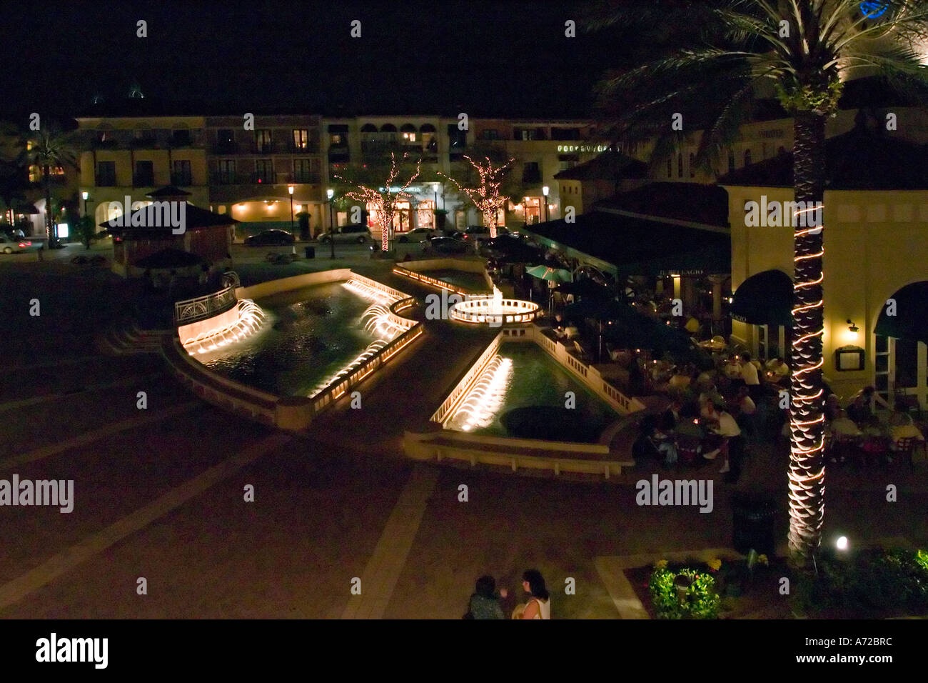 Night view of rear of Harriet Himmel Gilman Theater and Il Bellagio restaurant and fountain City Place West Palm Beach Florida Stock Photo