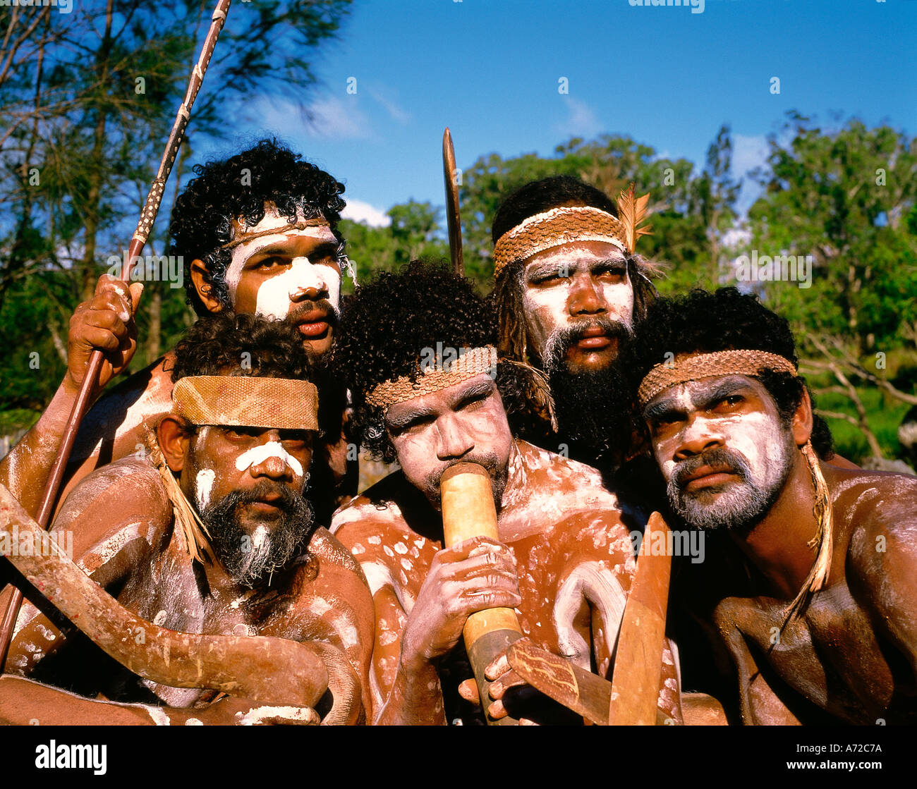 Native Aborigines blowing Didgeridoo Tjapukai Dance Group Cairns Queensland Australia Stock Photo