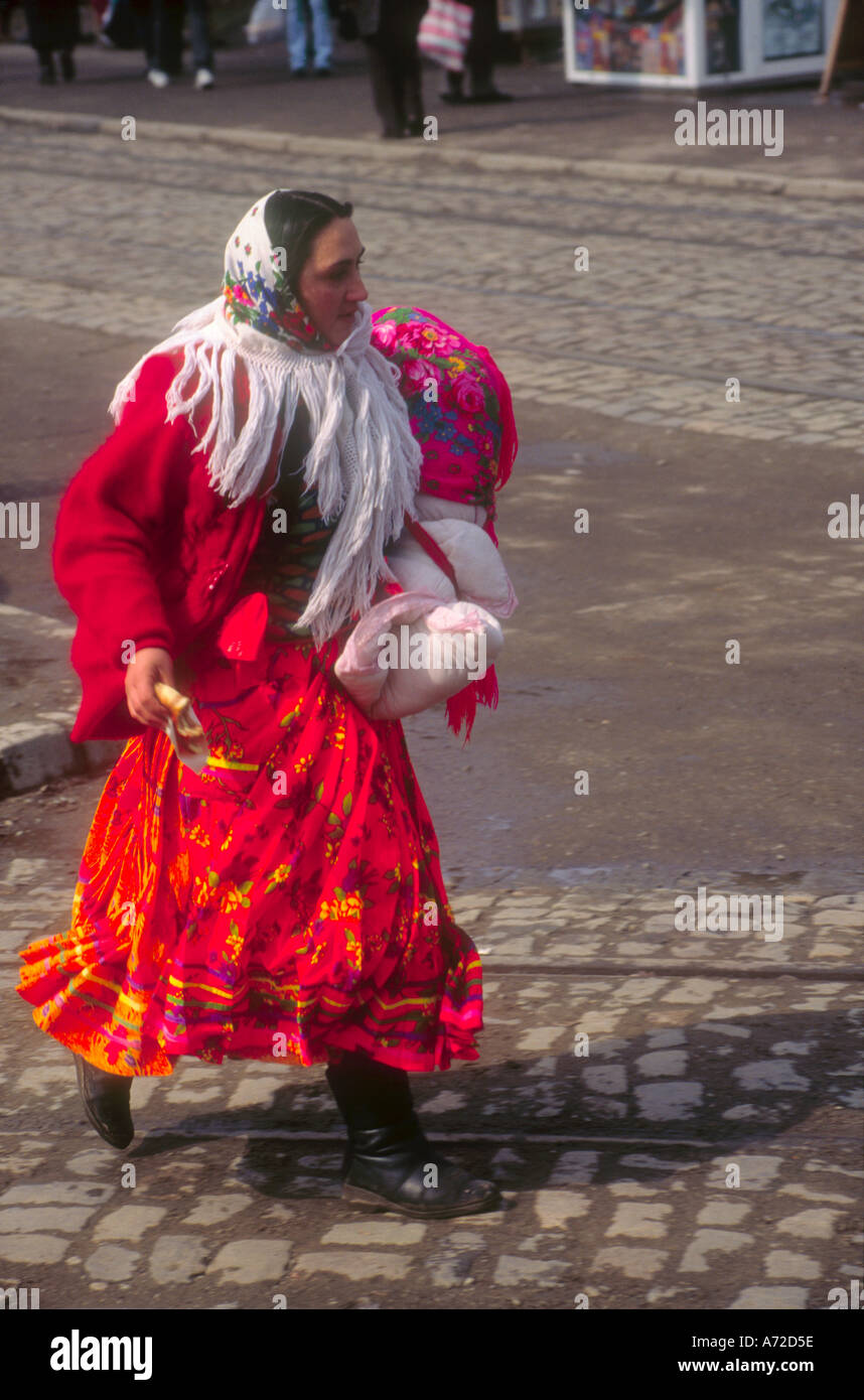 Roma woman in traditional dress with baby on Romanian streets Stock Photo