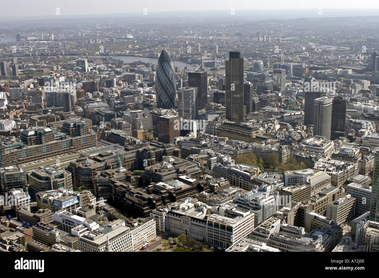 Aerial high level oblique view south east of City of London Broadgate Bishopsgate Swiss Re Gherkin 32 St Mary Axe Tower 42 Aviva Tower Bridge City Hall Finsbury Square and Circus EC2 EC3 EC4 England 2005 Stock Photo