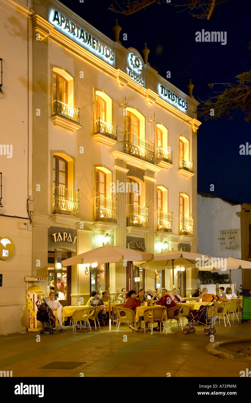 People sitting at pavement cafe at night plaza in the centre of Nerja Spain Stock Photo
