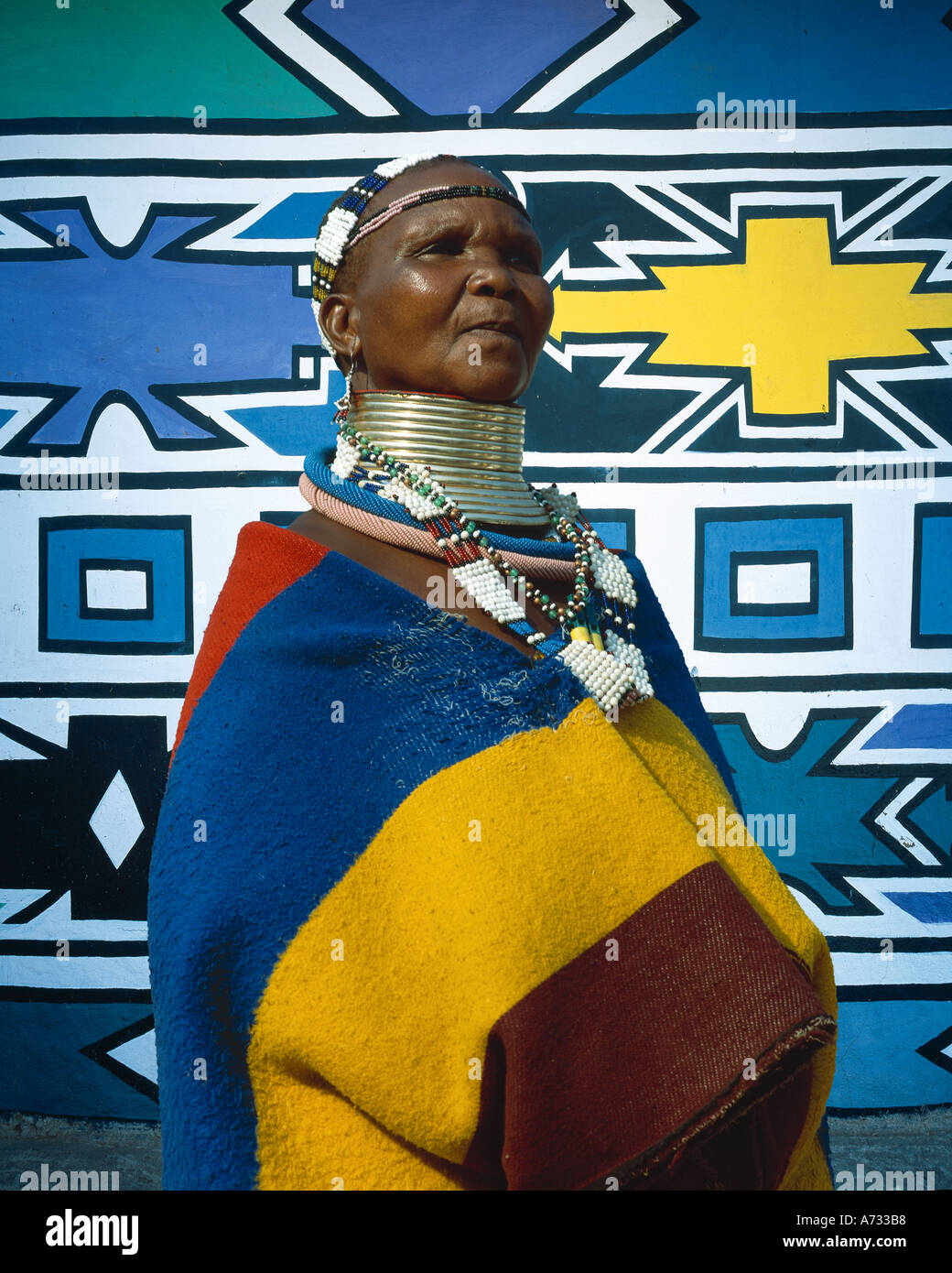 Ndebele tribal woman in front of traditionally decorated home,  near Johannesburg, South Africa Stock Photo
