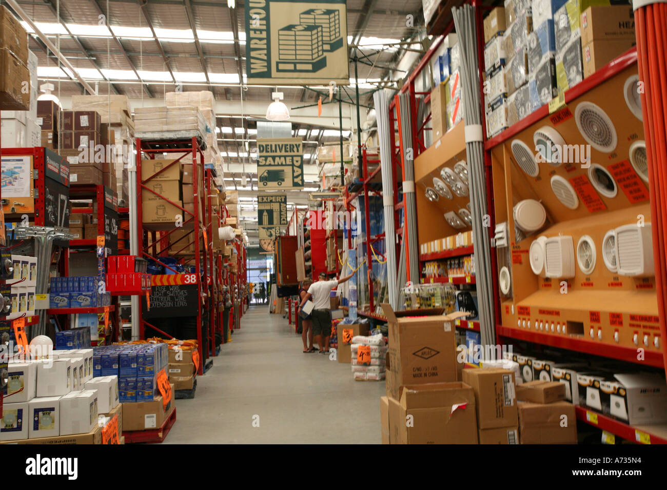 Aisle in a warehouse hardware store with goods on shelves and in Stock