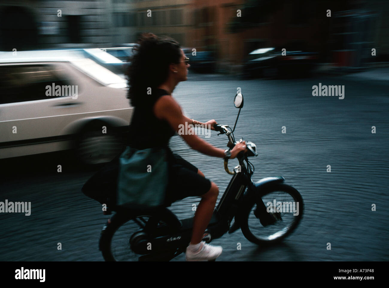 Girl riding a moped in Italy with no helmet 1970s Stock Photo 474952