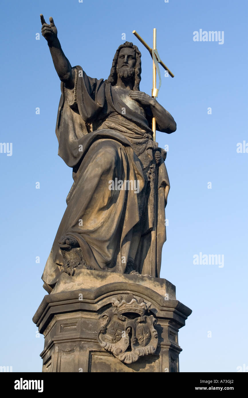 St John the Baptist and gold cross, statue on Charles Bridge, Prague ...