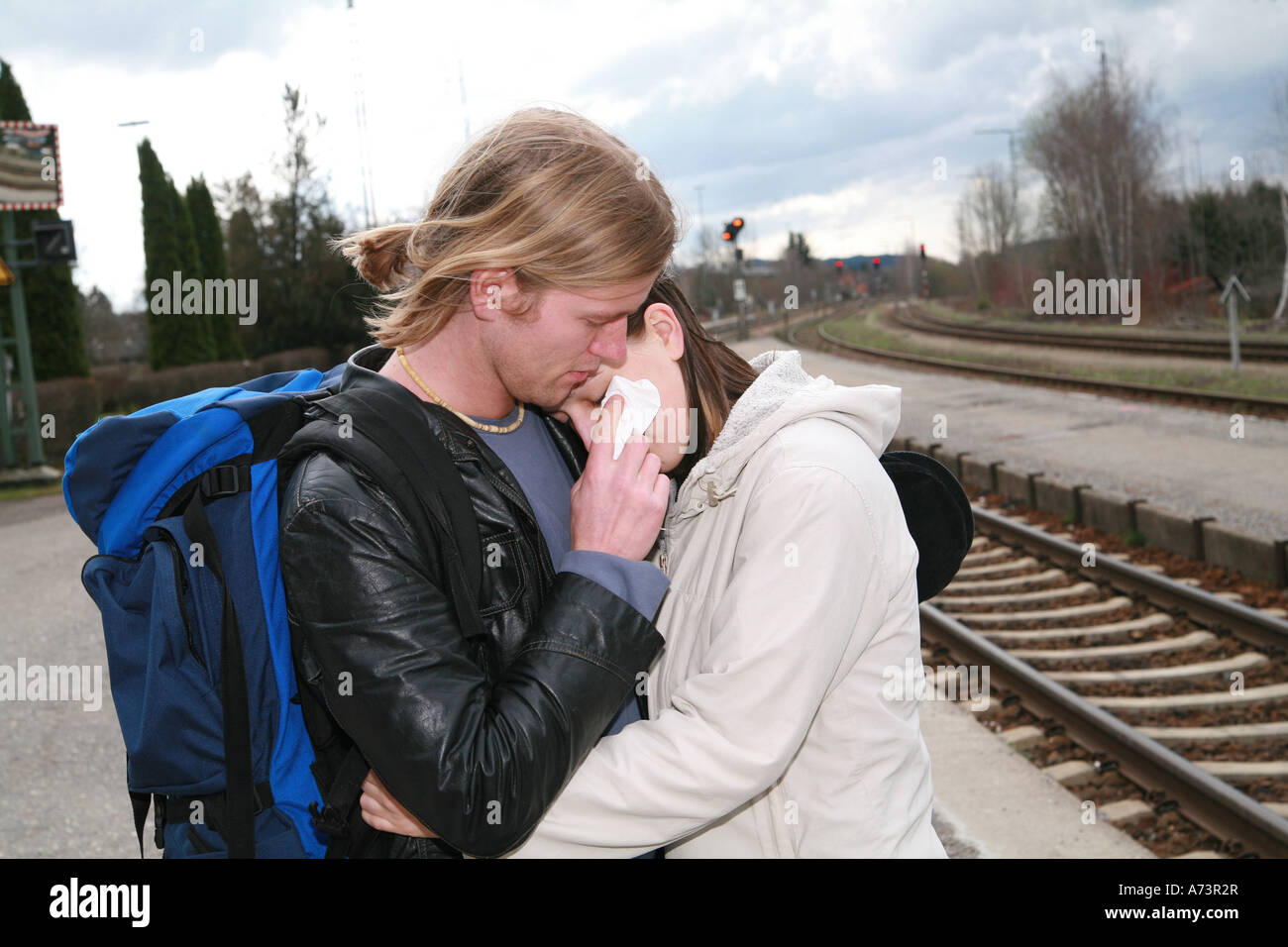 young couple at a railway station Stock Photo