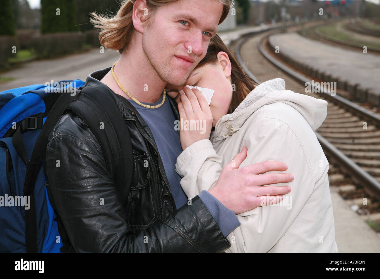young couple at a railway station Stock Photo