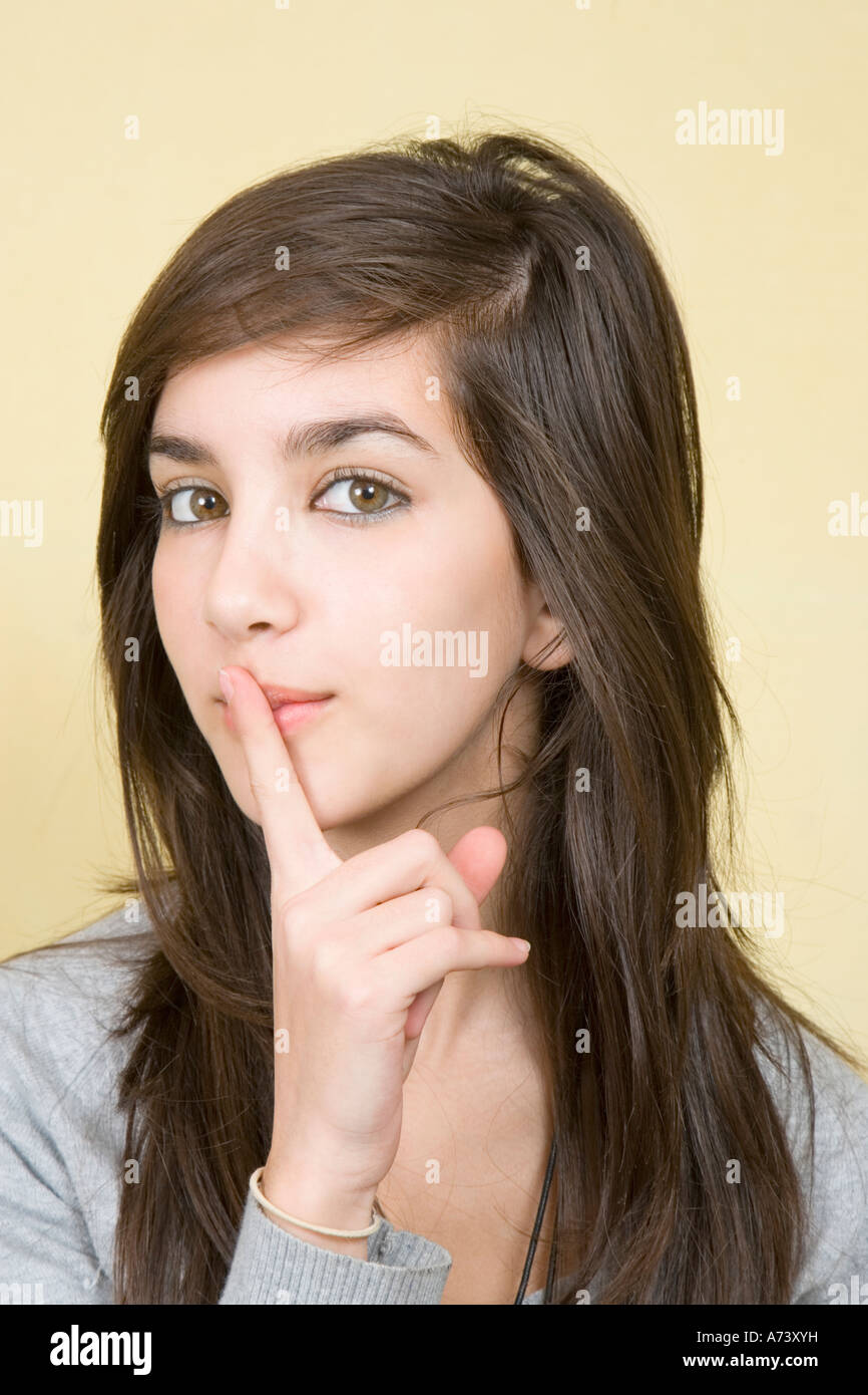 Portrait of Teenage Girl Holding Single Finger To Lips UK Stock Photo ...