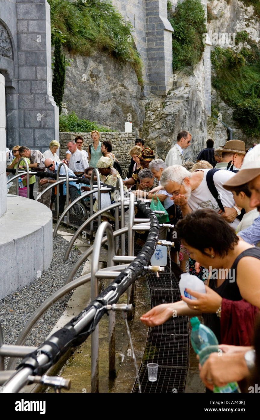 Pilgrims in Lourdes France drinking holy water Stock Photo Alamy