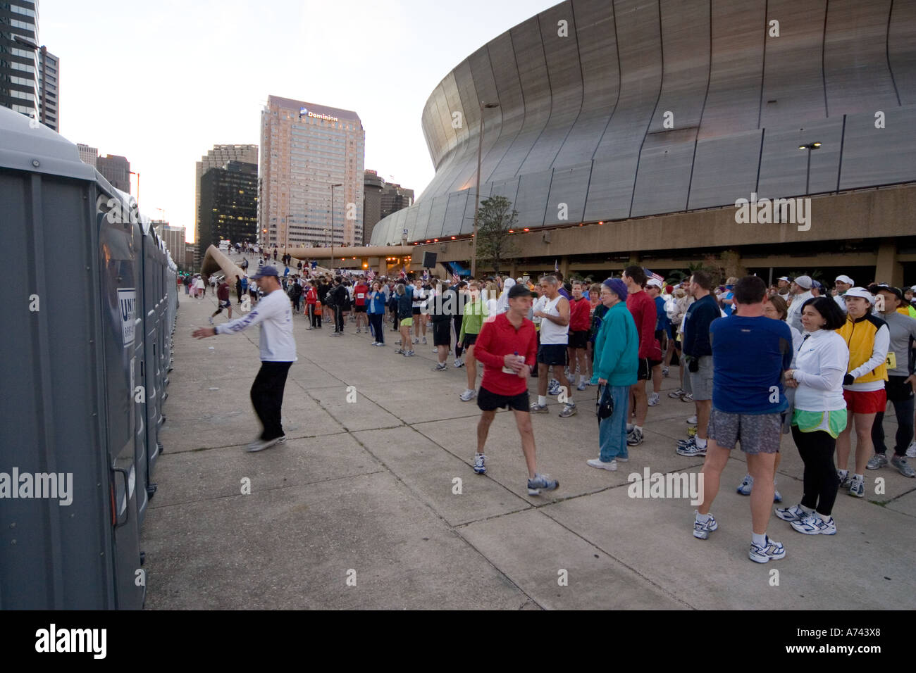 Runners wait in line to go to the bathroom before starting the Mardi