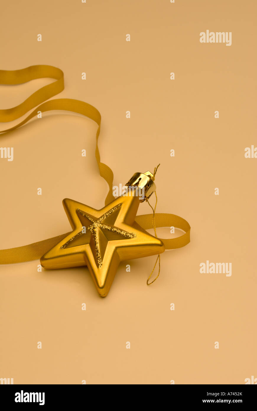 Bright Gold Christmas Star with Ribbon Isolated Stock Photo