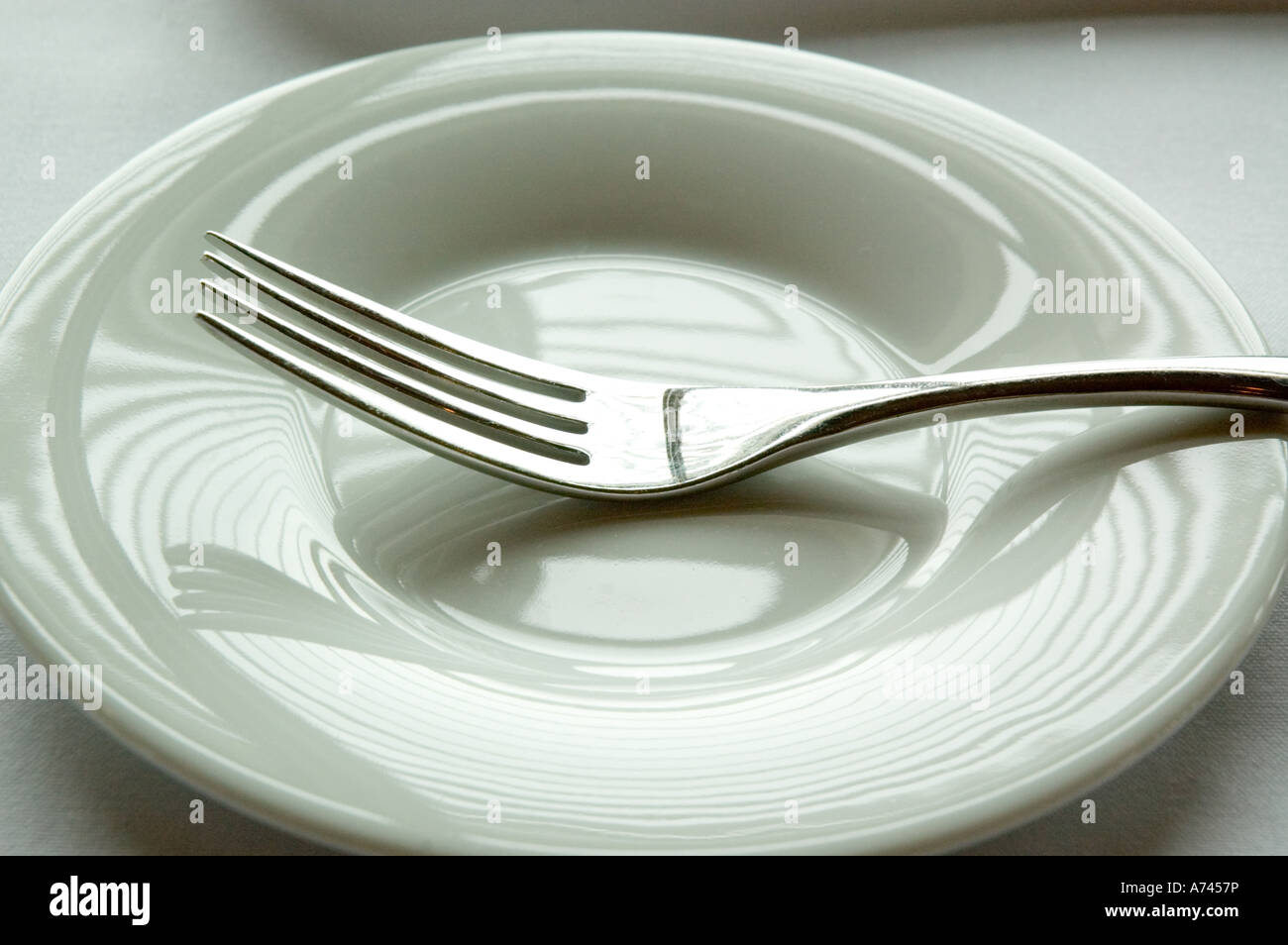 Silver fork on a side plate Stock Photo