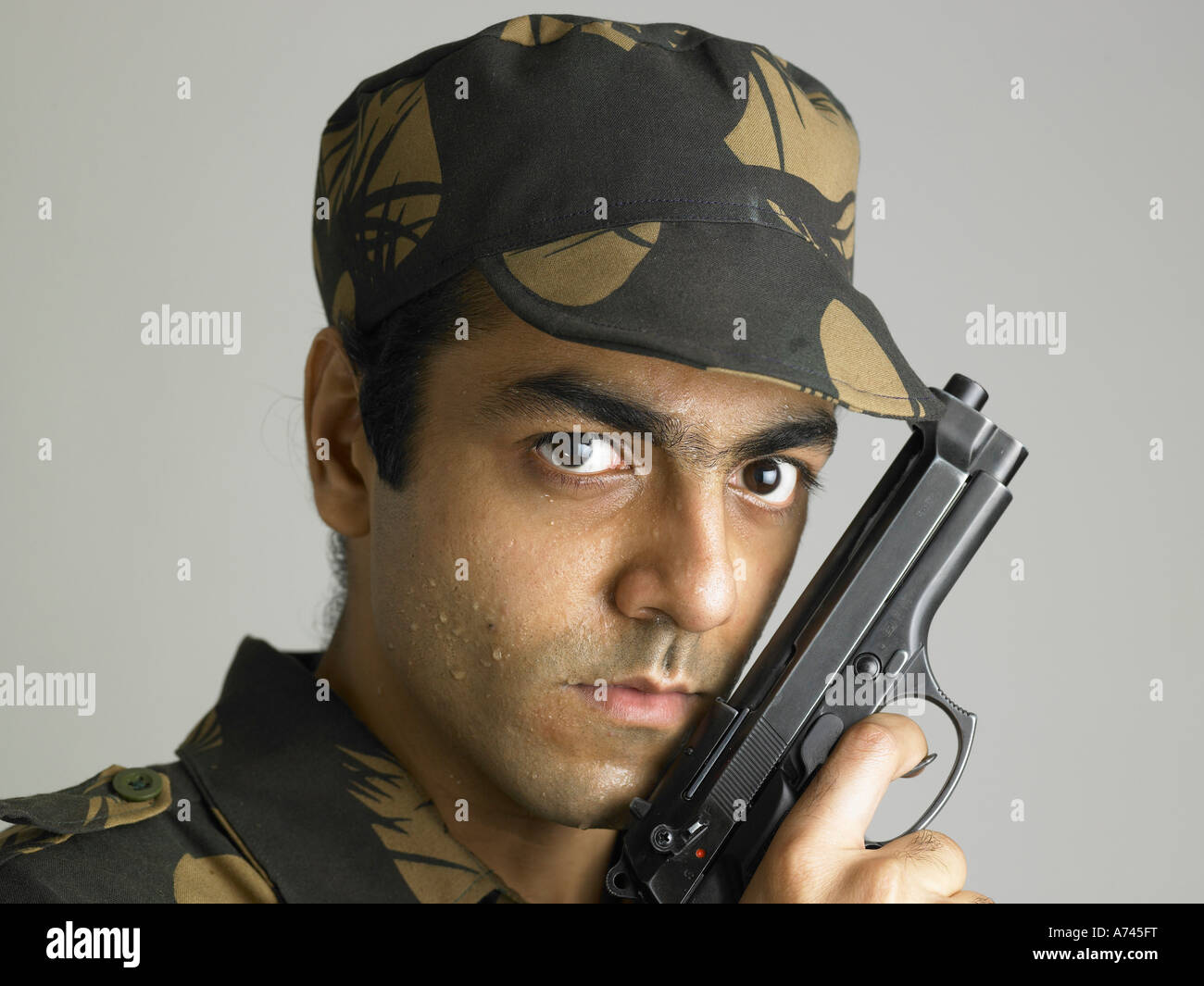 VDA 201755 Indian army soldier in angry expression holding handgun MR 702A Stock Photo