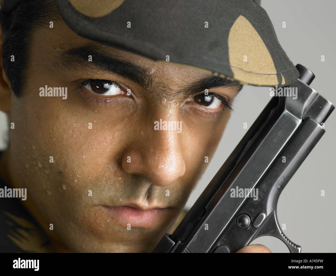 VDA 201756 Indian army soldier in angry expression holding handgun MR 702A Stock Photo