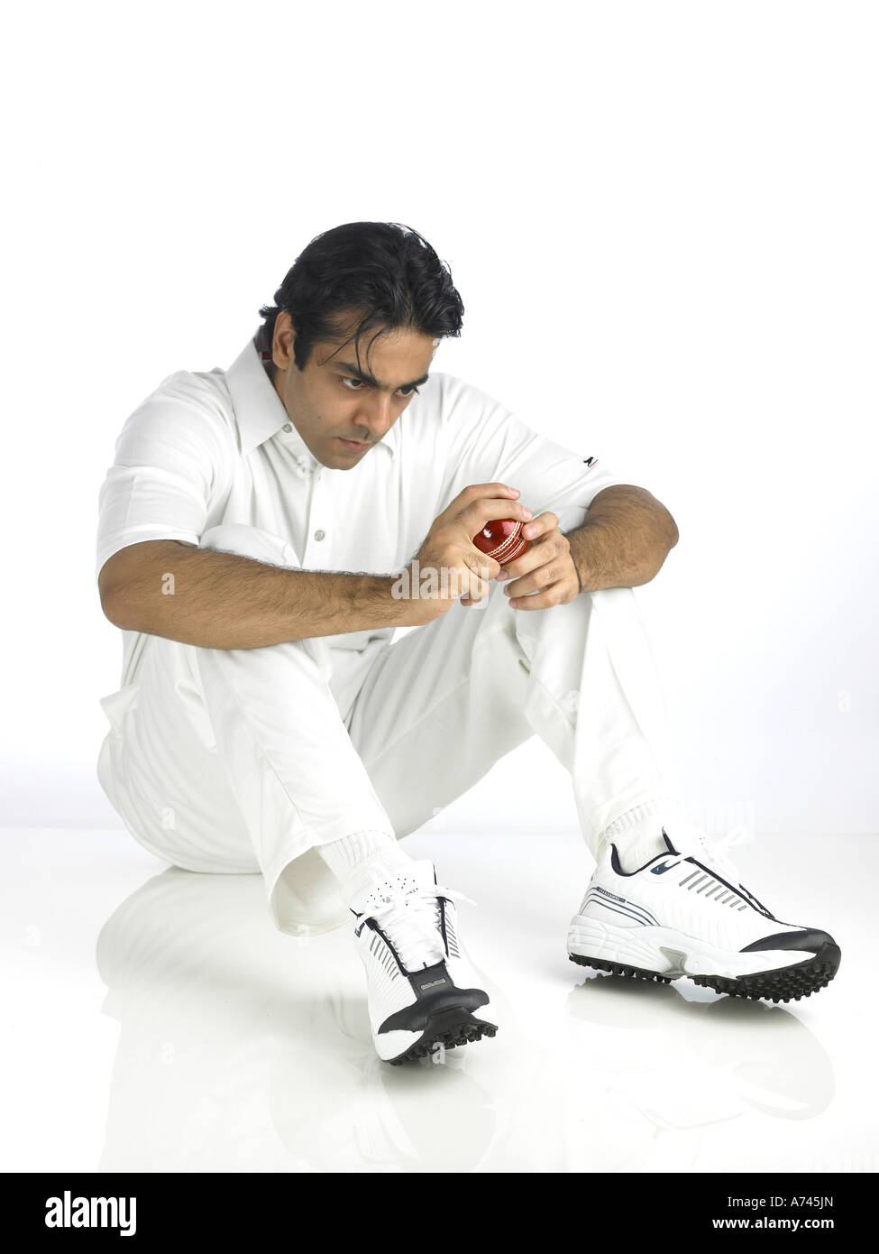 VDA 201786 Indian bowler sitting and looking at ball MR 702A Stock Photo