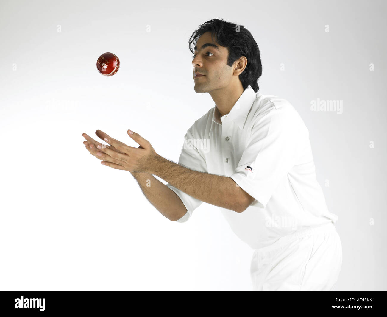 VDA 201795 Indian bowler in action of catching ball in cricket match MR 