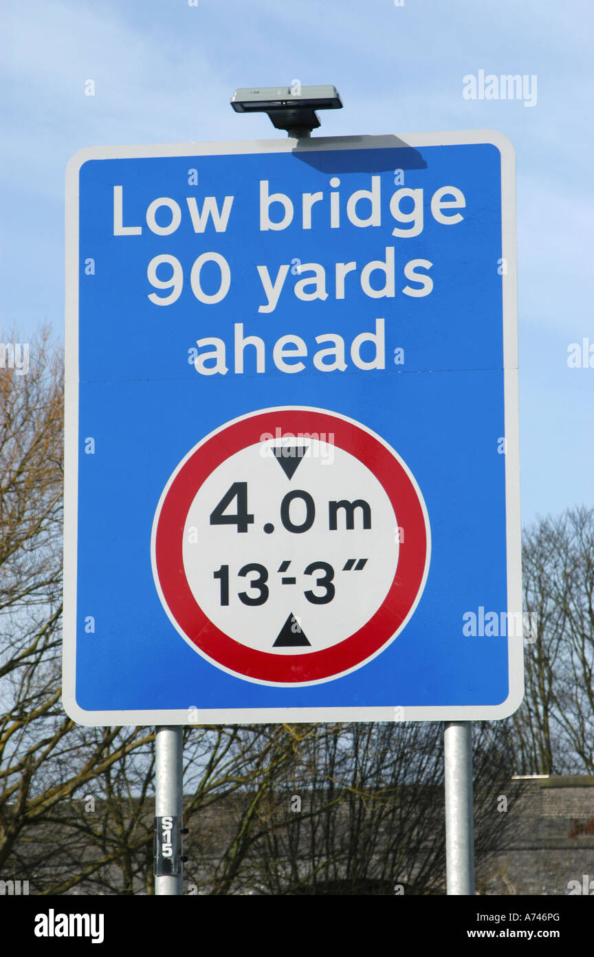 Road sign warning of a low bridge ahead on a road in the uk Stock Photo