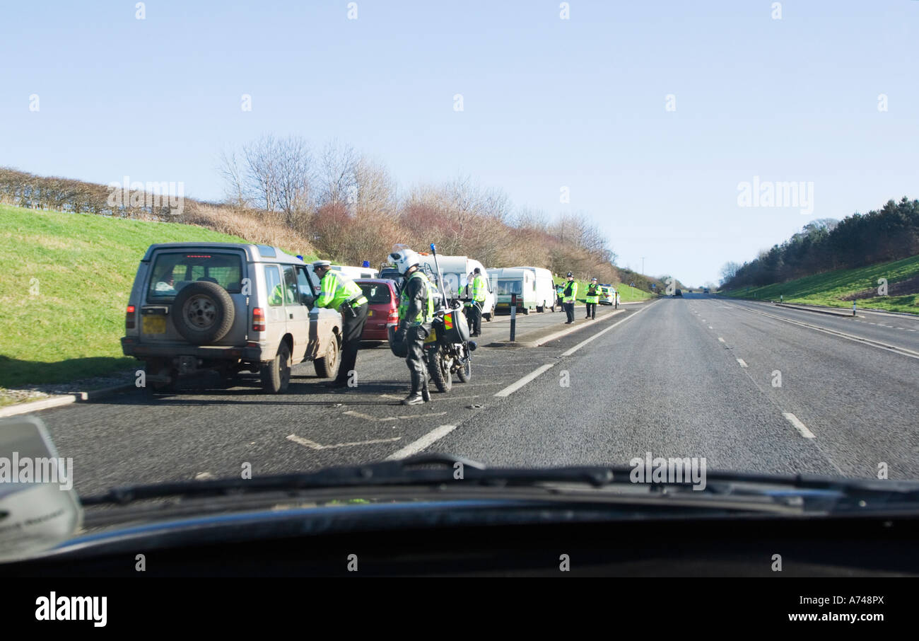 Police check point. Side of the road. View from a passing car. UK Stock