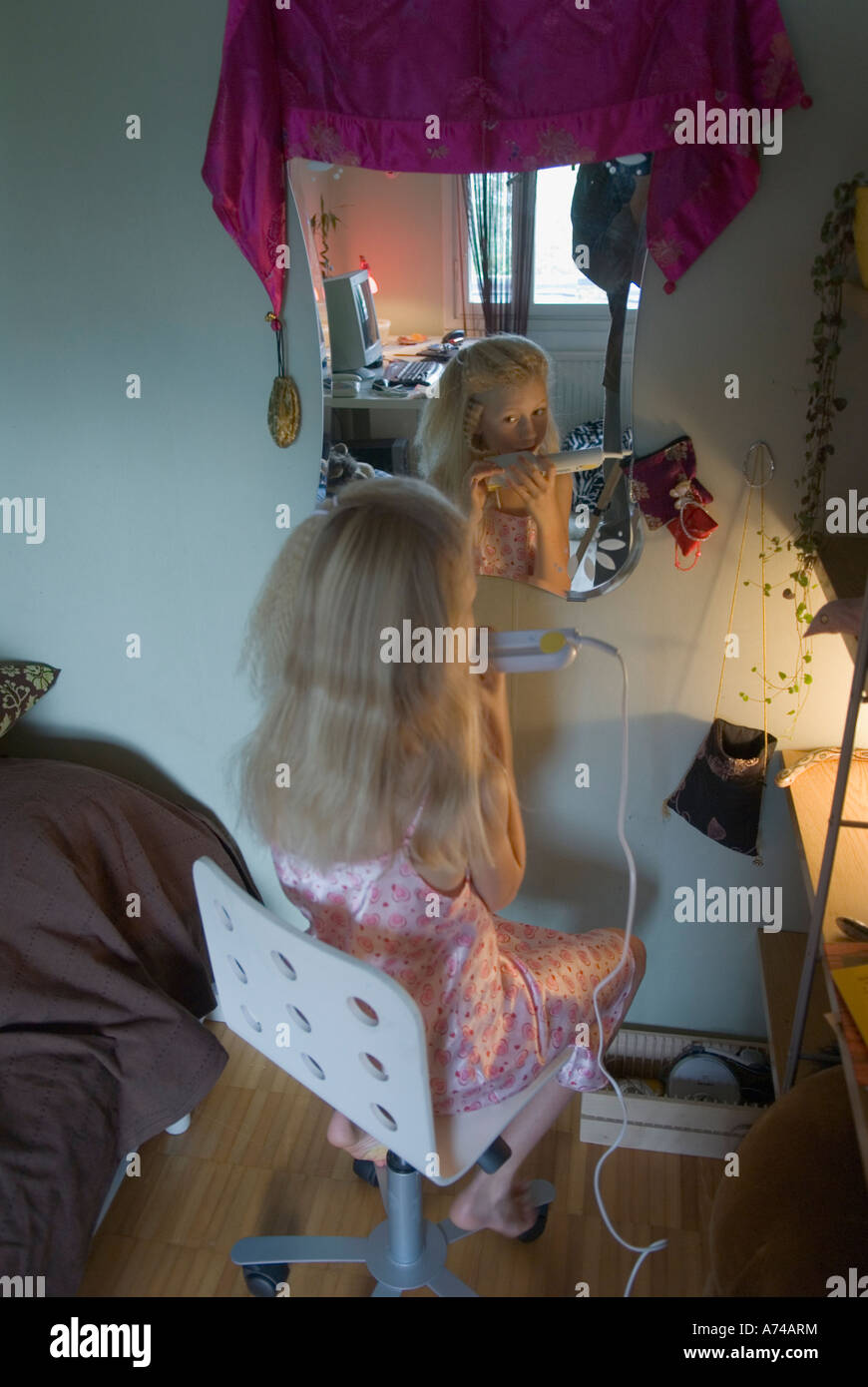 Young girl doing her hair Stock Photo Alamy