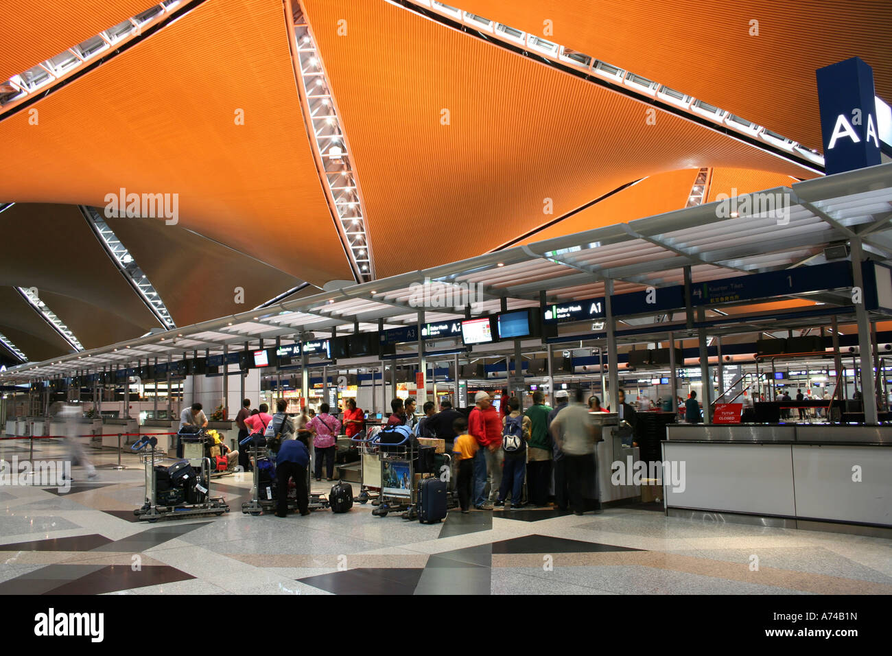 Travellers at Kuala Lumpur International Airport queueing to weigh