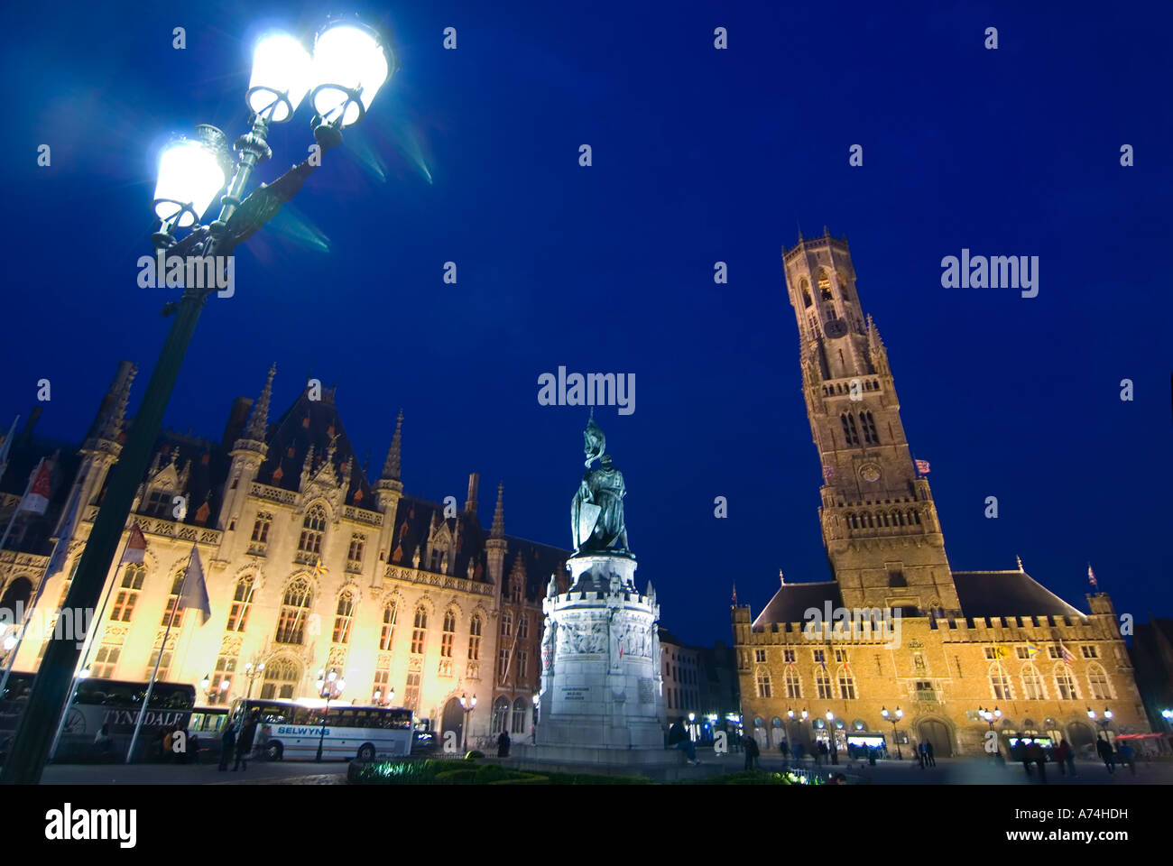 Horizontal cityscape of the Markt (Market Place) and the prominent Belfry of Bruges or Belfort van Brugge in Bruges at night. Stock Photo