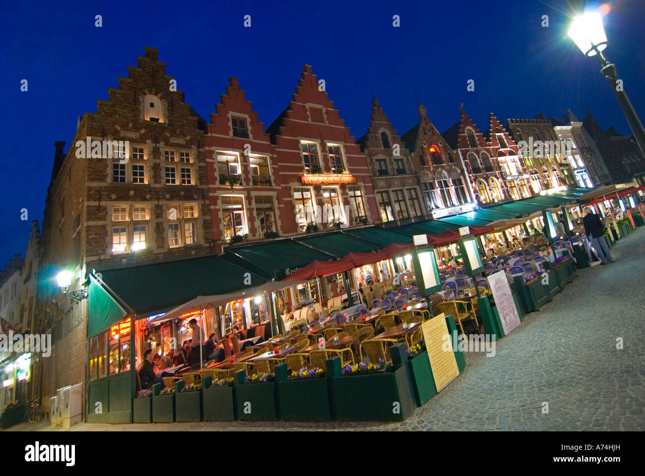 Horizontal wide angle of a row of traditional gabled houses in the Markt [Market Place] illuminated at night. Stock Photo