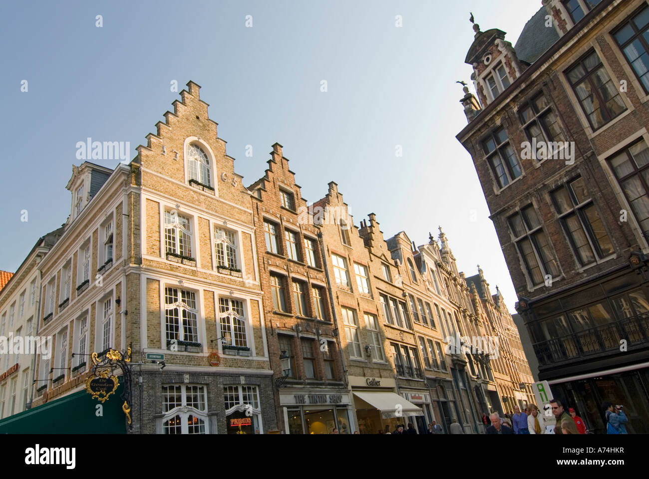 Horizontal view of the beautiful gabled shops on the corner of Steenstraat and the Markt [Market Place] on a sunny day in Bruges. Stock Photo