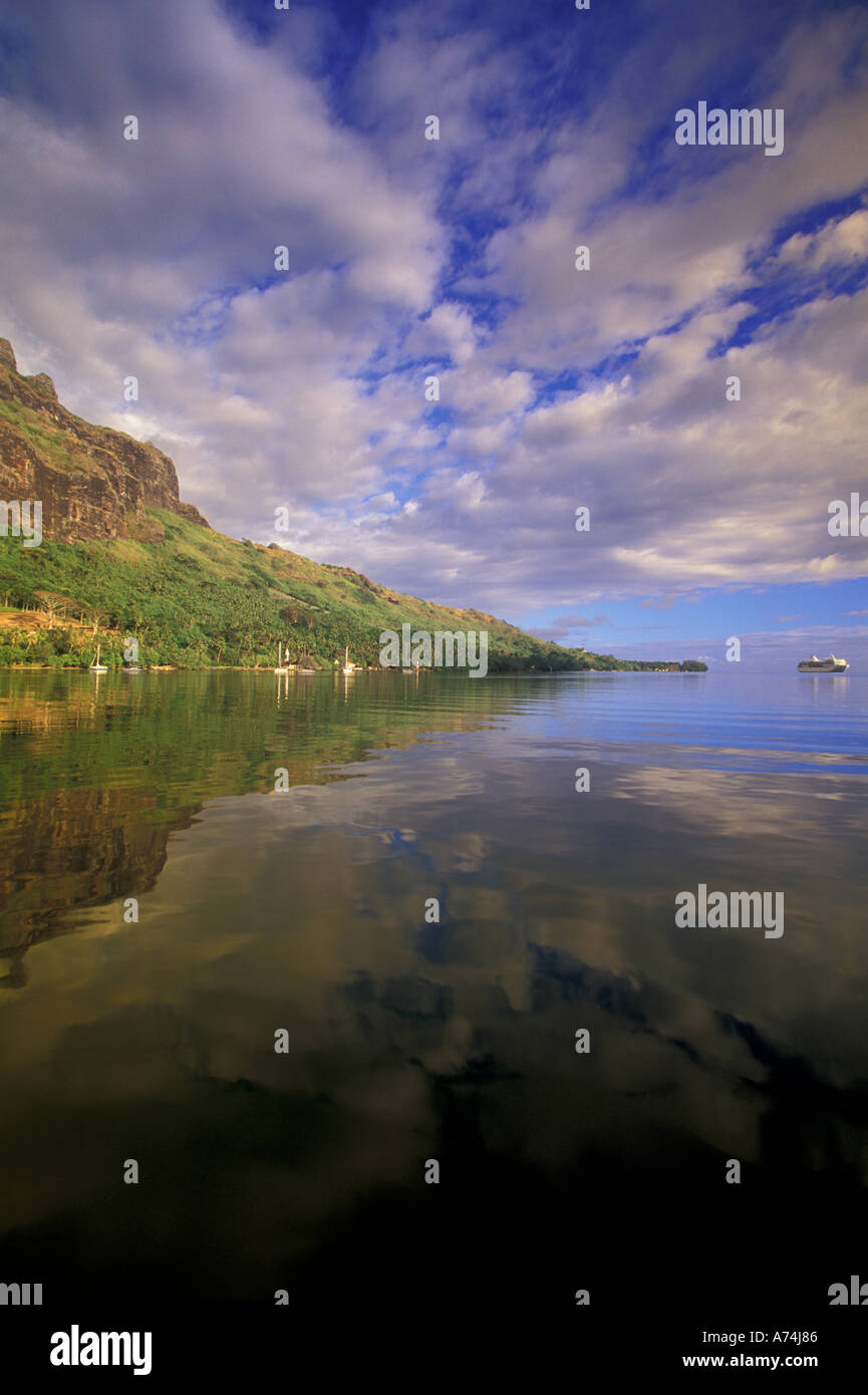 French Polynesia, Moorea. Cooks Bay. Cruise ship Paul Gaugin and bay reflection Stock Photo