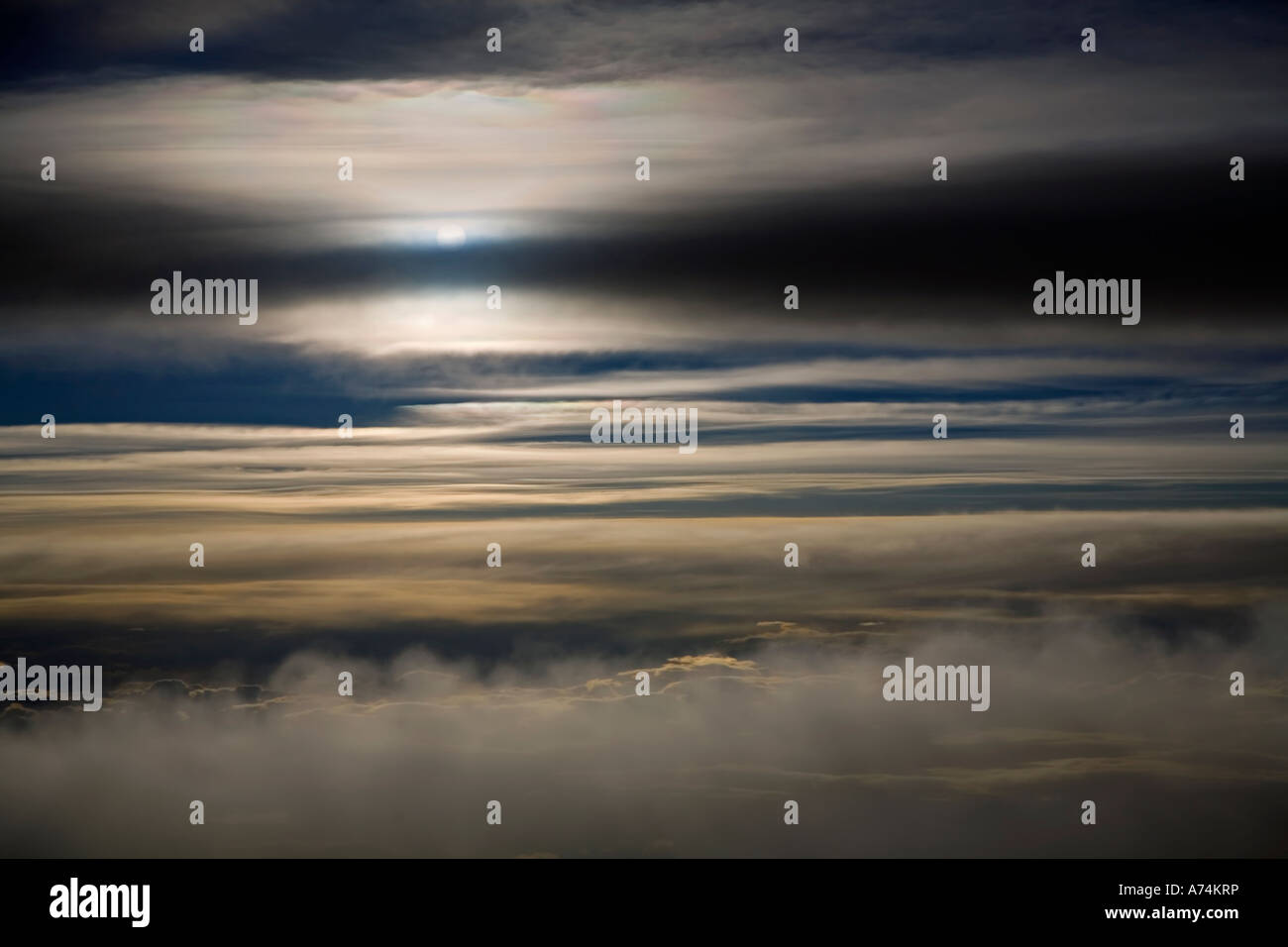 Sunrise through clouds from above Stock Photo
