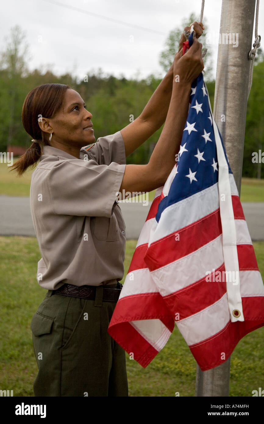 Park Service Employee Raises Flag Stock Photo