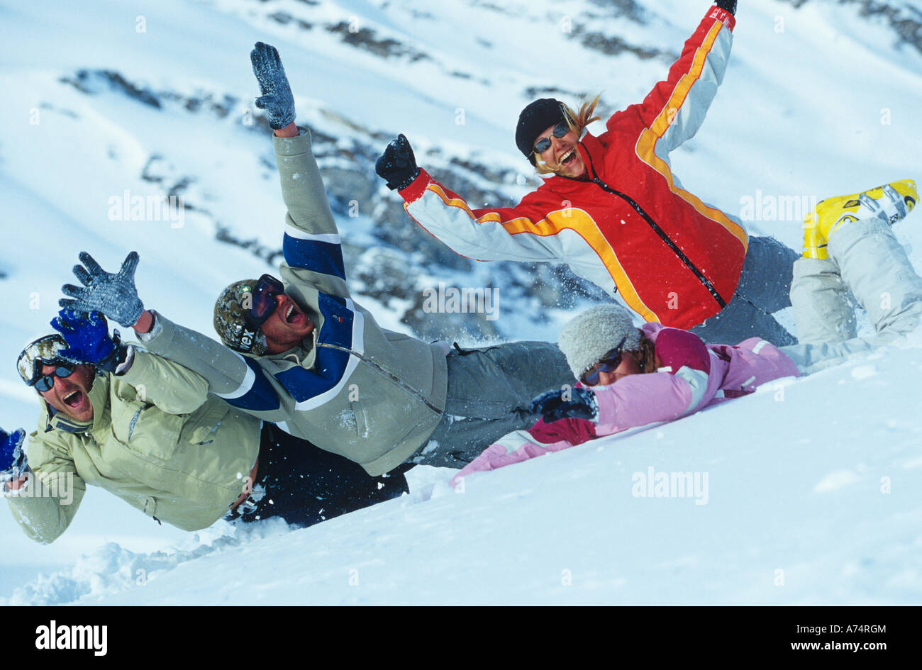 Fun In Snow group of four friends having fun in snow together Stock Photo - Alamy