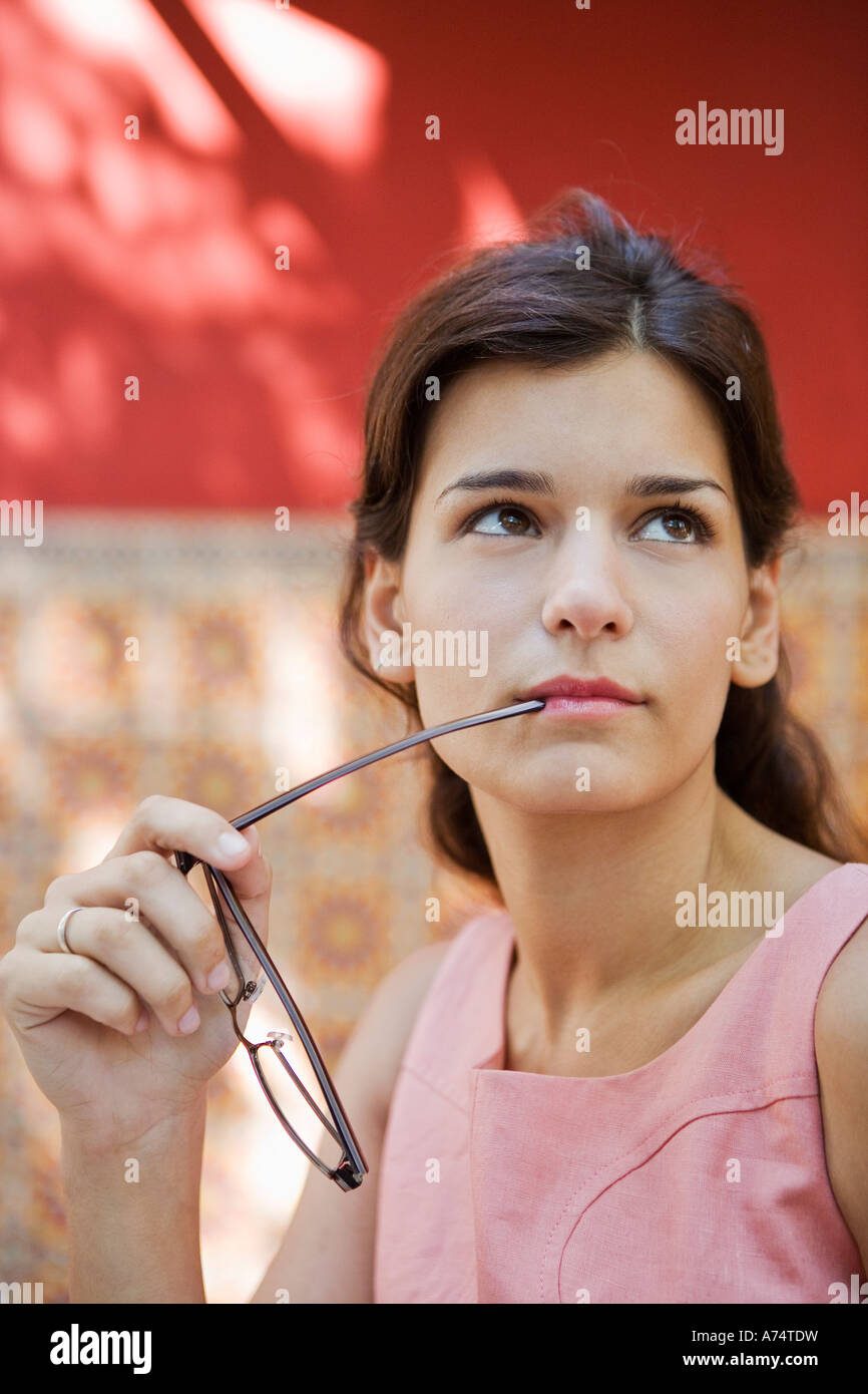 Woman chewing on glasses Stock Photo Alamy