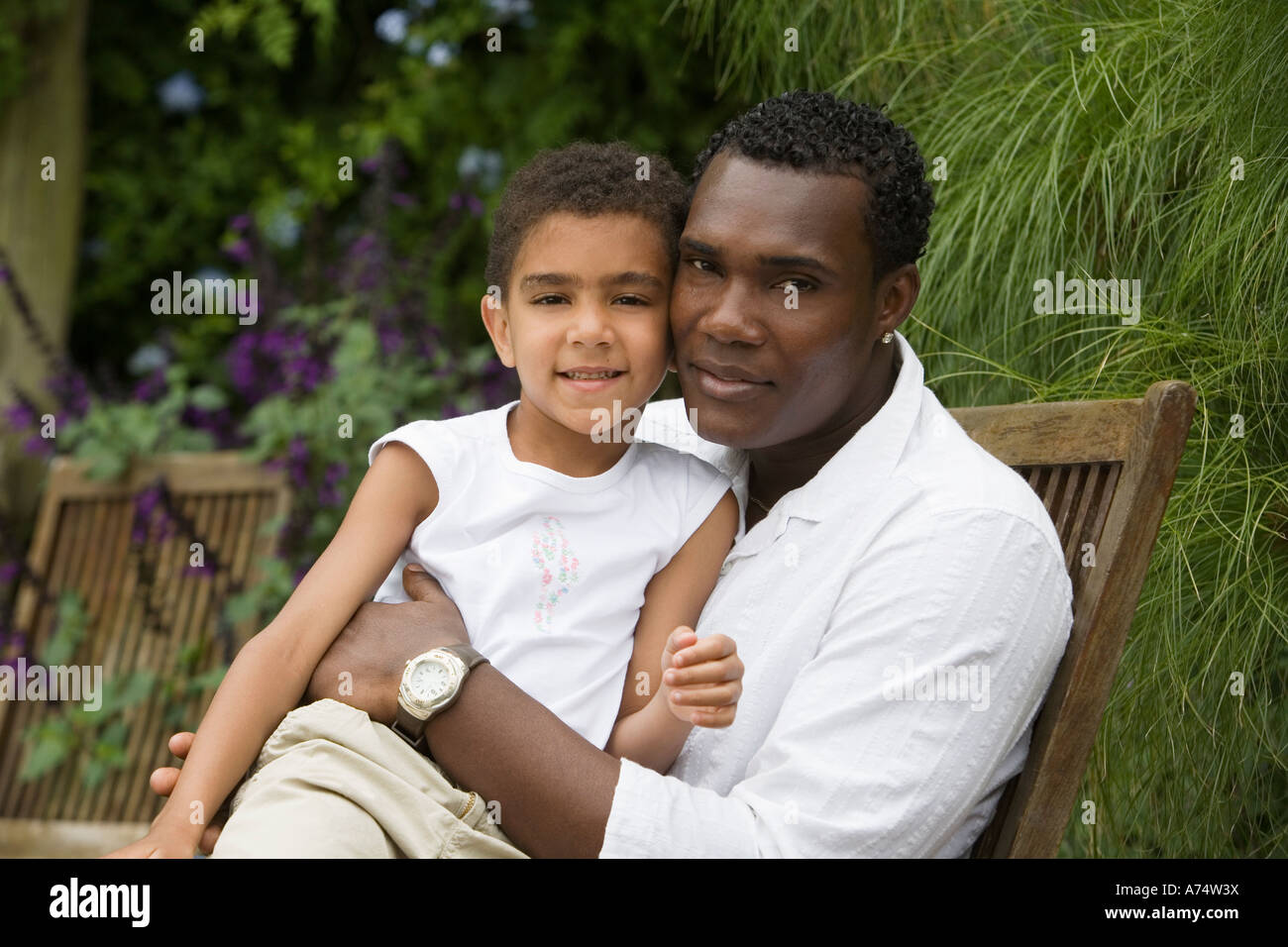 Boy sitting on father's lap hi-res stock photography and images - Alamy