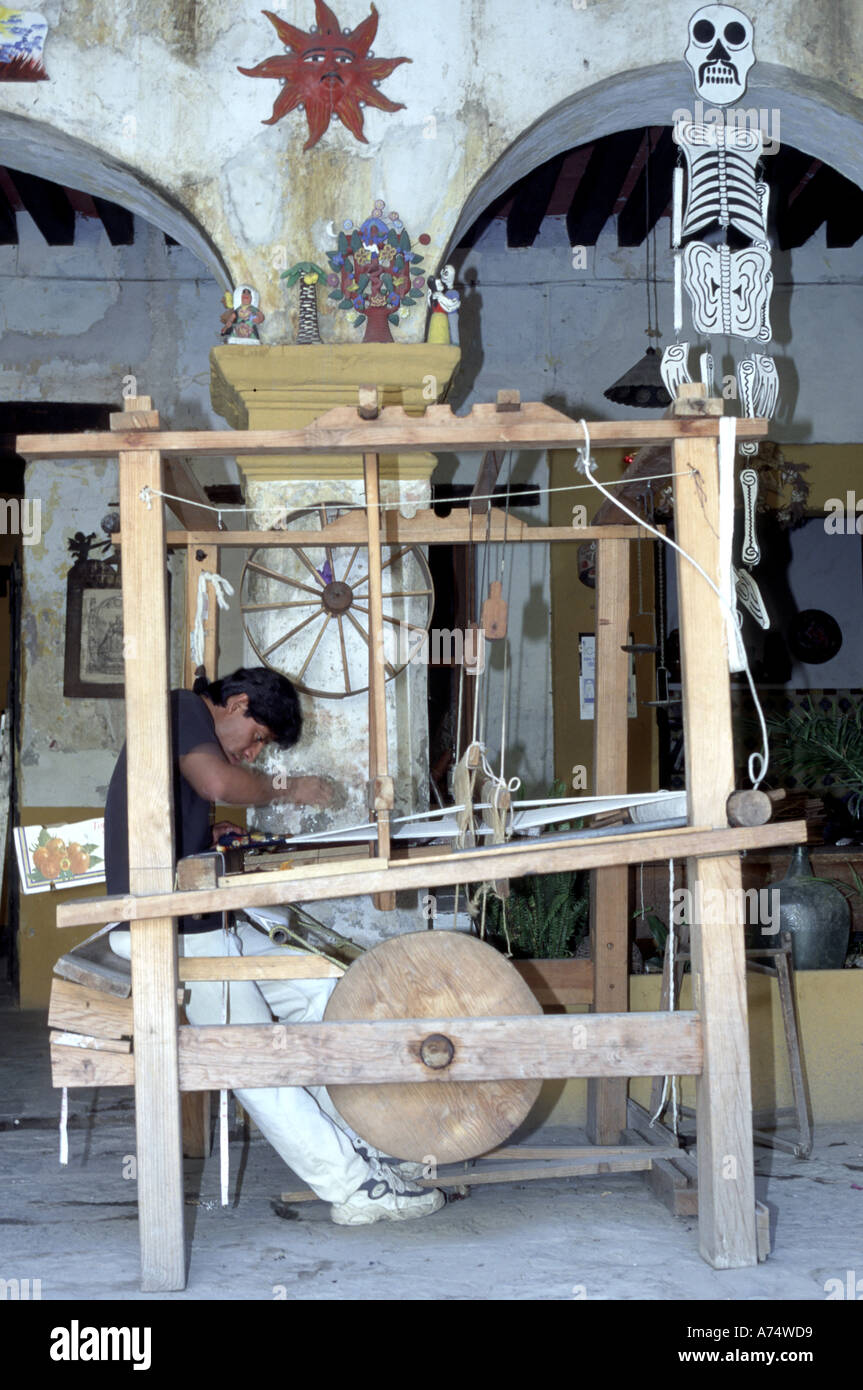 Mexico, Oaxaca. Man weaving on a traditional loom in one of Oaxaca's