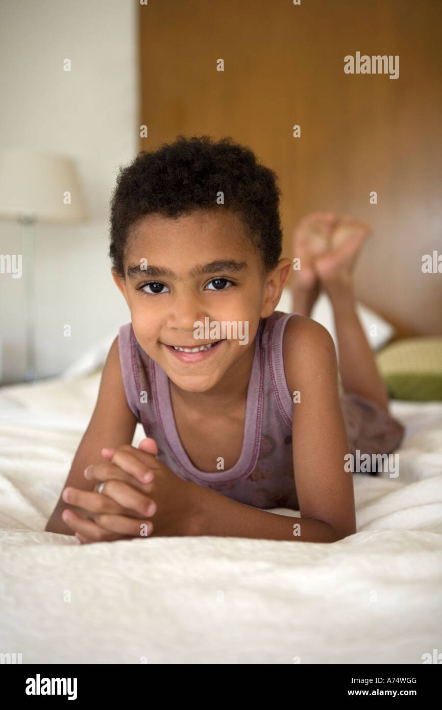 Young boy laying on bed Stock Photo Alamy