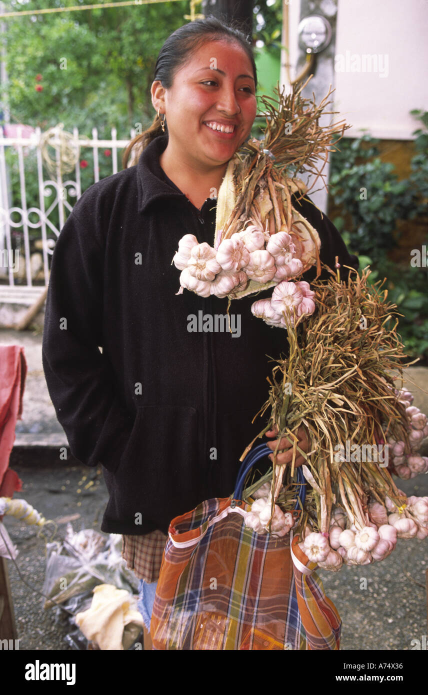 Mexico, Tobasco, Emiliano Zapata. Woman sells garlic at street market