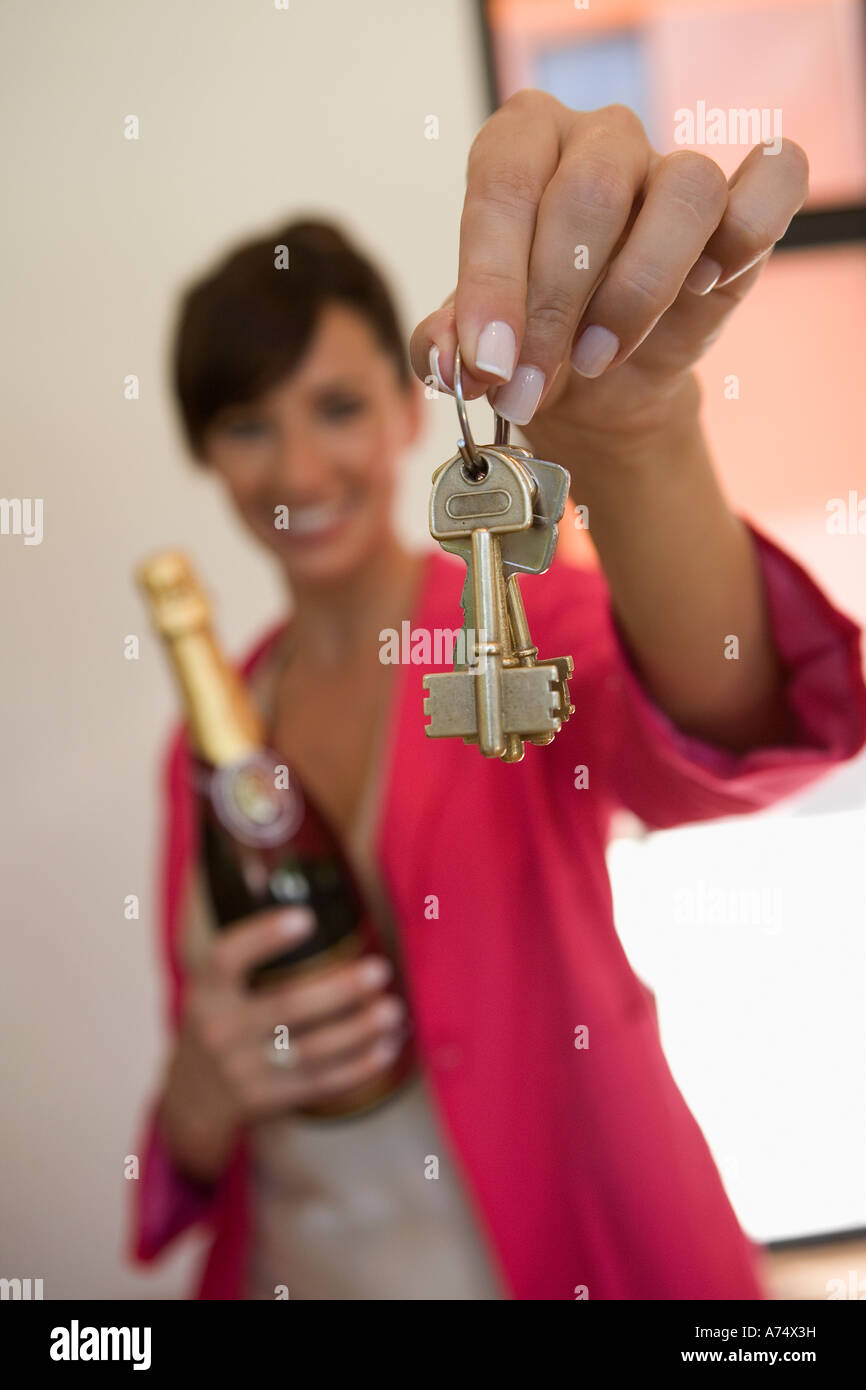 Real estate agent holding out house keys Stock Photo - Alamy
