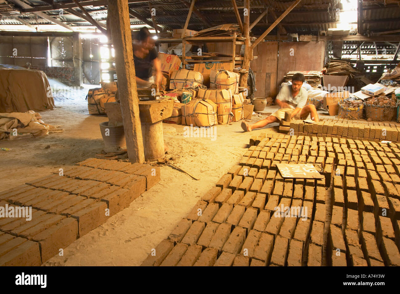 People Making Bricks In Factory Stock Photo