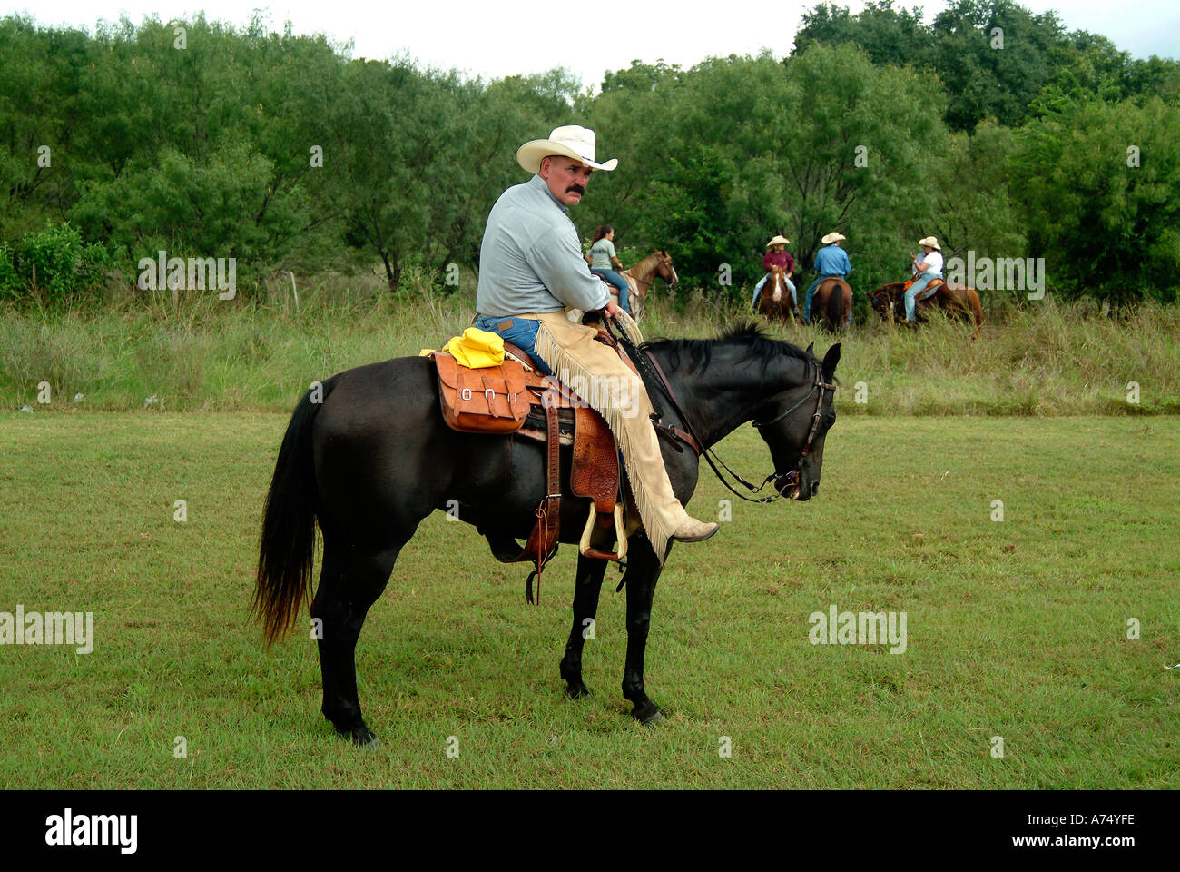 A cowboy riding a horse in Bandera Texas Stock Photo Alamy