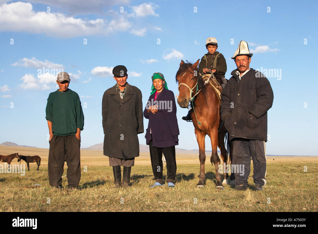 Kyrgyz Herder Family Standing In Late Afternoon Sunshine Stock Photo